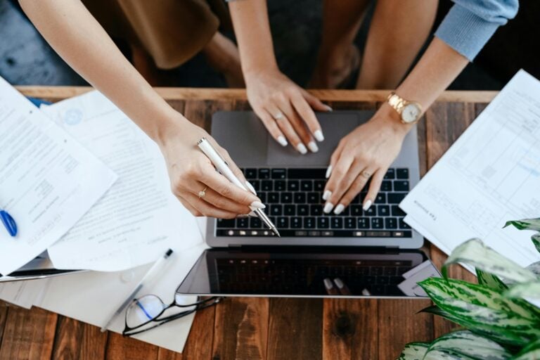 Two people working on a laptop